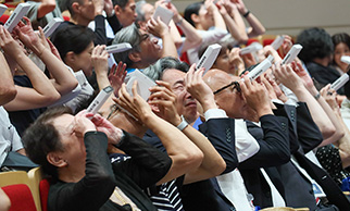 分光器でLED照明を観察する来場者の様子