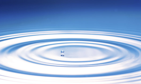 image of a drop that causes circular waves on the water surface